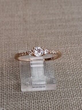 Delicate Gold Tone Solitaire Ring with Pavé Accents